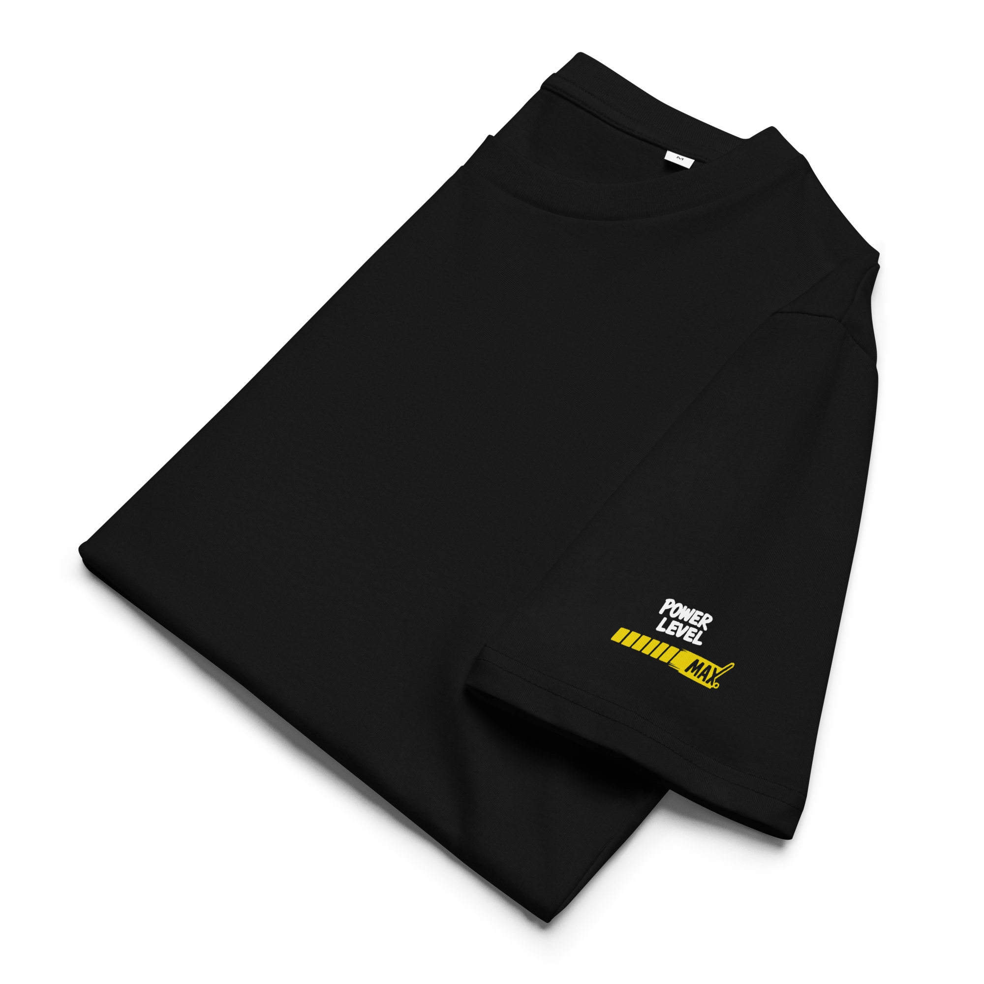 Folded black T-shirt, close-up of sleeve with yellow “Power Level – MAX” bar graphic. Minimalist anime/gaming detail on a high-quality, sustainable cotton tee.