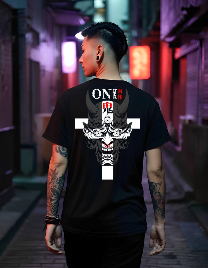 Male model wearing a black T-shirt with a bold Oni demon design in a neon-lit alleyway. Japanese streetwear meets modern sustainability with eco-friendly materials, high-quality production, and top-certified fashion standards.